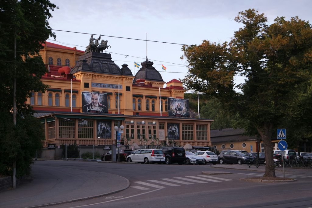 cars parked in front of brown building during daytime