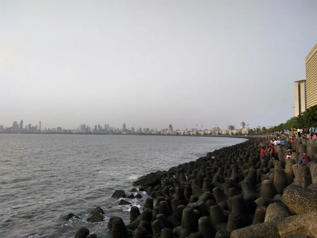 a group of people standing on the edge of a body of water